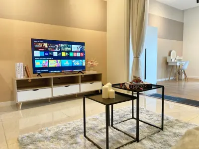 a living room with a flat screen tv on a wall at Quill Residences KL By Minos Home in Kuala Lumpur
