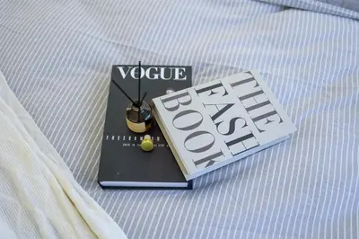 a book sitting on a bed with a clock on it at Quill Residences KL By Minos Home in Kuala Lumpur