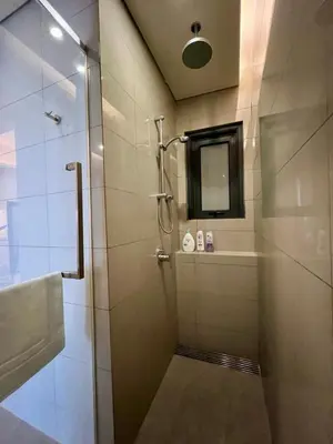 a bathroom with a shower with a glass door at Tribeca Residence Bukit Bintang in Kuala Lumpur