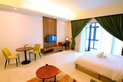 a hotel room with a bed and a television at Tribeca Residence Bukit Bintang in Kuala Lumpur
