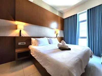 a hotel room with a teddy bear sitting on a bed at Tribeca Residence Bukit Bintang in Kuala Lumpur