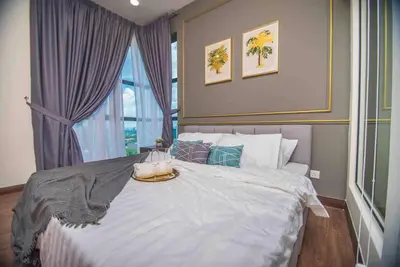a bedroom with a large bed with a tray on it at Arte Mont Kiara in Kuala Lumpur