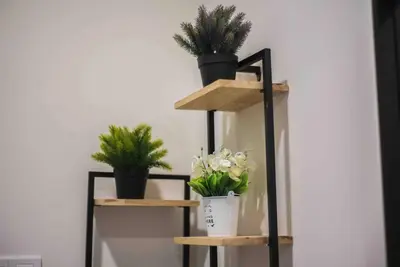 a shelf with potted plants on top of it at Arte Mont Kiara in Kuala Lumpur