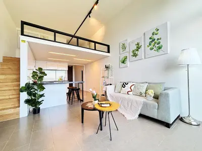 a living room with a couch and a loft at The Establishment Bangsar KL by Lynhomes in Kuala Lumpur