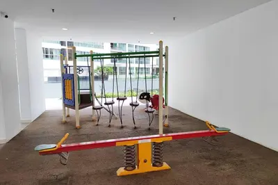 a play equipment in a room with a simulator at Spacious Home for 6pax - Regalia Suite - Infinity Pool with KL City View - Free Wi-Fi & Parking in Kuala Lumpur
