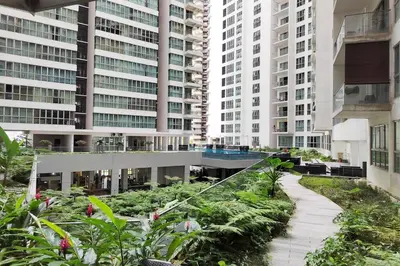 a walkway in a city with tall buildings at Spacious Home for 6pax - Regalia Suite - Infinity Pool with KL City View - Free Wi-Fi & Parking in Kuala Lumpur