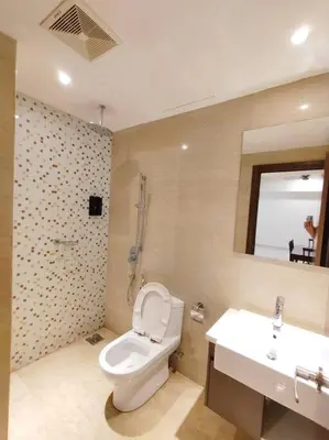 a bathroom with a toilet and a sink at Spacious Home for 6pax - Regalia Suite - Infinity Pool with KL City View - Free Wi-Fi & Parking in Kuala Lumpur