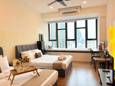 a hotel room with two beds and a table at KLCC VIEW,5 mins to KL TOWER in Kuala Lumpur