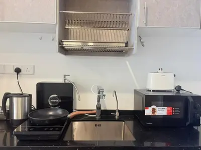 a kitchen counter with a sink and a microwave at KLCC VIEW,5 mins to KL TOWER in Kuala Lumpur