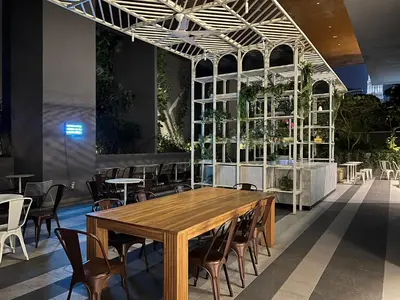 a dining room with a wooden table and chairs at KLCC VIEW,5 mins to KL TOWER in Kuala Lumpur