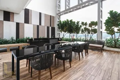 a restaurant with black tables and chairs and a large window at Colony Chow Kit Guesthouse in Kuala Lumpur