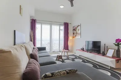 a living room with a couch and a tv at Studio with an amazing view. 10 min to KLCC in Kuala Lumpur