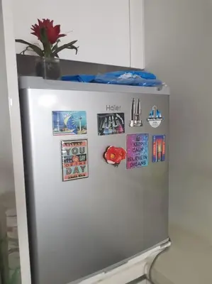 a refrigerator with magnets and pictures on it at Studio with an amazing view. 10 min to KLCC in Kuala Lumpur