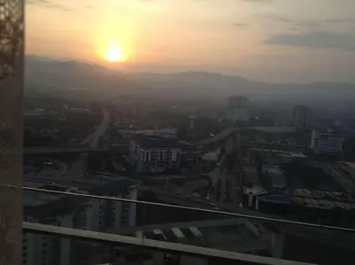 a view of a city with the sunset in the background at Studio with an amazing view. 10 min to KLCC in Kuala Lumpur