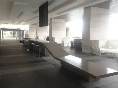 a lobby with white chairs and a long bench at Studio with an amazing view. 10 min to KLCC in Kuala Lumpur