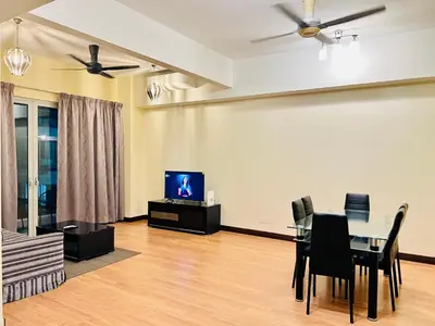 a living room with a dining table and a tv at Regalia Spritz Empire Hostel in Kuala Lumpur