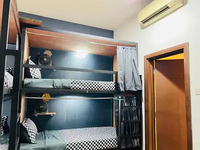 a room with bunk beds in a room with aiger at Regalia Spritz Empire Hostel in Kuala Lumpur