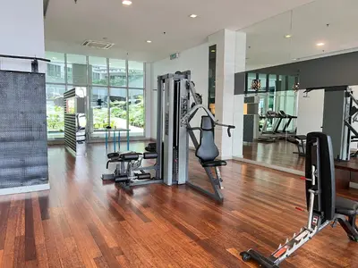 a gym with treadmills and machines in a room at Regalia Spritz Empire Hostel in Kuala Lumpur