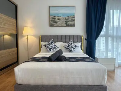 a bedroom with a large bed with blue curtains at Quill Residences KlCC By G Z in Kuala Lumpur