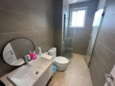 a bathroom with a sink and a toilet and a mirror at Quill Residences KlCC By G Z in Kuala Lumpur