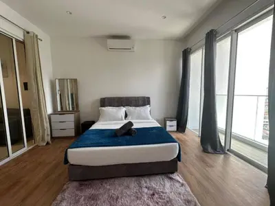 a bedroom with a bed with a teddy bear on it at Quill Residences KlCC By G Z in Kuala Lumpur