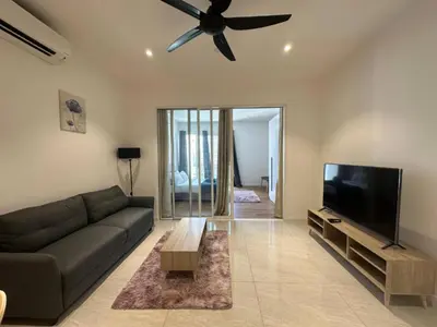 a living room with a couch and a flat screen tv at Quill Residences KlCC By G Z in Kuala Lumpur