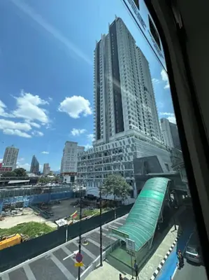 a view of a tall building from a window at Quill Residences KlCC By G Z in Kuala Lumpur