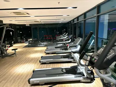 a row of treadmills in a gym at The Luxe Suites KLCC by Cozy Stay in Kuala Lumpur
