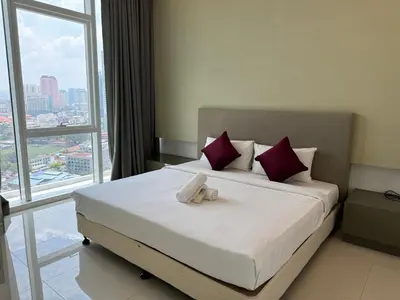 a bedroom with a bed with two towels on it at Platinum suites by BLUE SKY in Kuala Lumpur