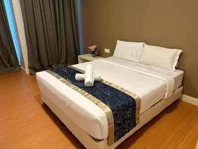 a bedroom with a bed with a stuffed animal on it at Platinum suites by BLUE SKY in Kuala Lumpur
