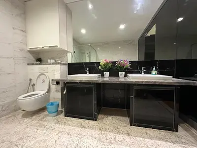a bathroom with two sinks and a toilet in it at Platinum suites by BLUE SKY in Kuala Lumpur