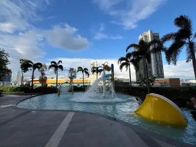a water slide in a park with palm trees at Trion @ KL By Awesomestay in Kuala Lumpur