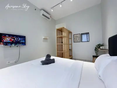 a bedroom with a white bed with a teddy bear sitting on it at Trion @ KL By Awesomestay in Kuala Lumpur