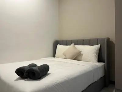 a bed with a stuffed animal on top of it at Neu Suites By Awesomestay in Kuala Lumpur