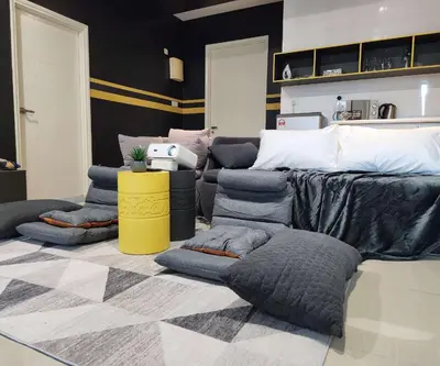 a room with a bed with lots of pillows at Arte Plus Kuala Lumpur by Inn Lux in Kuala Lumpur