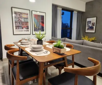 a dining room with a wooden table and chairs at Arte Plus Kuala Lumpur by Inn Lux in Kuala Lumpur