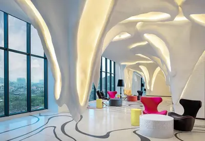 a lobby with chairs and tables in a building at Arte Plus Kuala Lumpur by Inn Lux in Kuala Lumpur