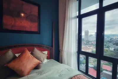 a bedroom with a bed and a large window at King Studio Suite Legasi Kampung Bharu view KLCC in Kuala Lumpur