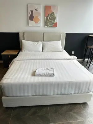 a bedroom with a large bed with a white mattress at Scarletz Suites KLCC Kuala Lumpur by OKIDOKI Homes in Kuala Lumpur
