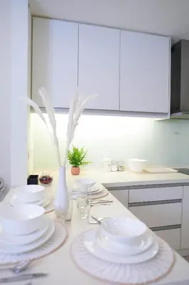 a kitchen with white plates and a vase on a counter at 7 PAX, 1BR, 3mins to KLCC (3A3A) in Kuala Lumpur
