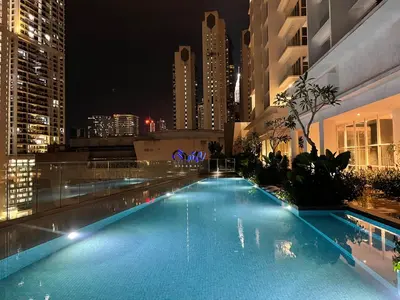 a swimming pool on the roof of a building at night at Quill Residence Premium Cozy Suite By Ares Homestay in Kuala Lumpur