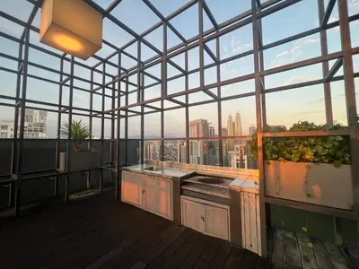 a rooftop kitchen with a view of the city at Anggun KL Mal in Kuala Lumpur