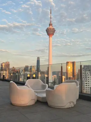 a rooftop with chairs and a view of the space needle at Anggun KL Mal in Kuala Lumpur