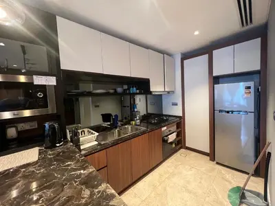 a kitchen with white cabinets and a stainless steel refrigerator at Anggun KL Mal in Kuala Lumpur