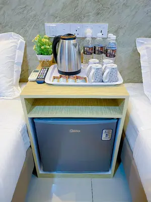 a table with a tea kettle on top of a bed at StarQ Hotel Bukit Bintang in Kuala Lumpur
