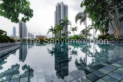 a swimming pool with palm trees and buildings at TRION Studio 4 PAX Eleventen in Kuala Lumpur