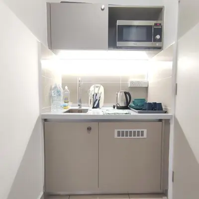 a small kitchen with a sink and a microwave at TRION Studio 4 PAX Eleventen in Kuala Lumpur