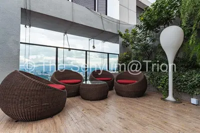 a row of wicker chairs sitting on a balcony at TRION Studio 4 PAX Teneleven in Kuala Lumpur