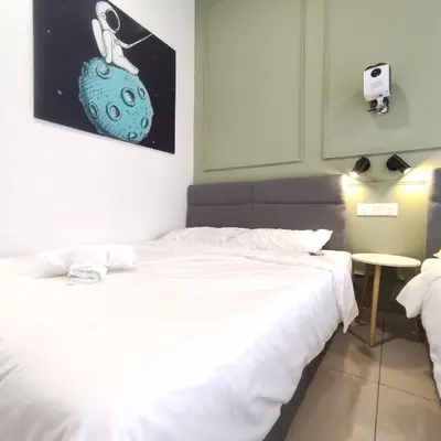a bedroom with a bed and a picture of a bug at TRION Studio 4 PAX Teneleven in Kuala Lumpur