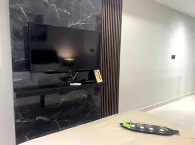 a flat screen tv sitting on top of a black wall at Novo KL, Astonishing Unique Executive Suite in Kuala Lumpur